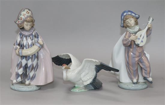 Two Lladro figures of harlequins and another of a crane
